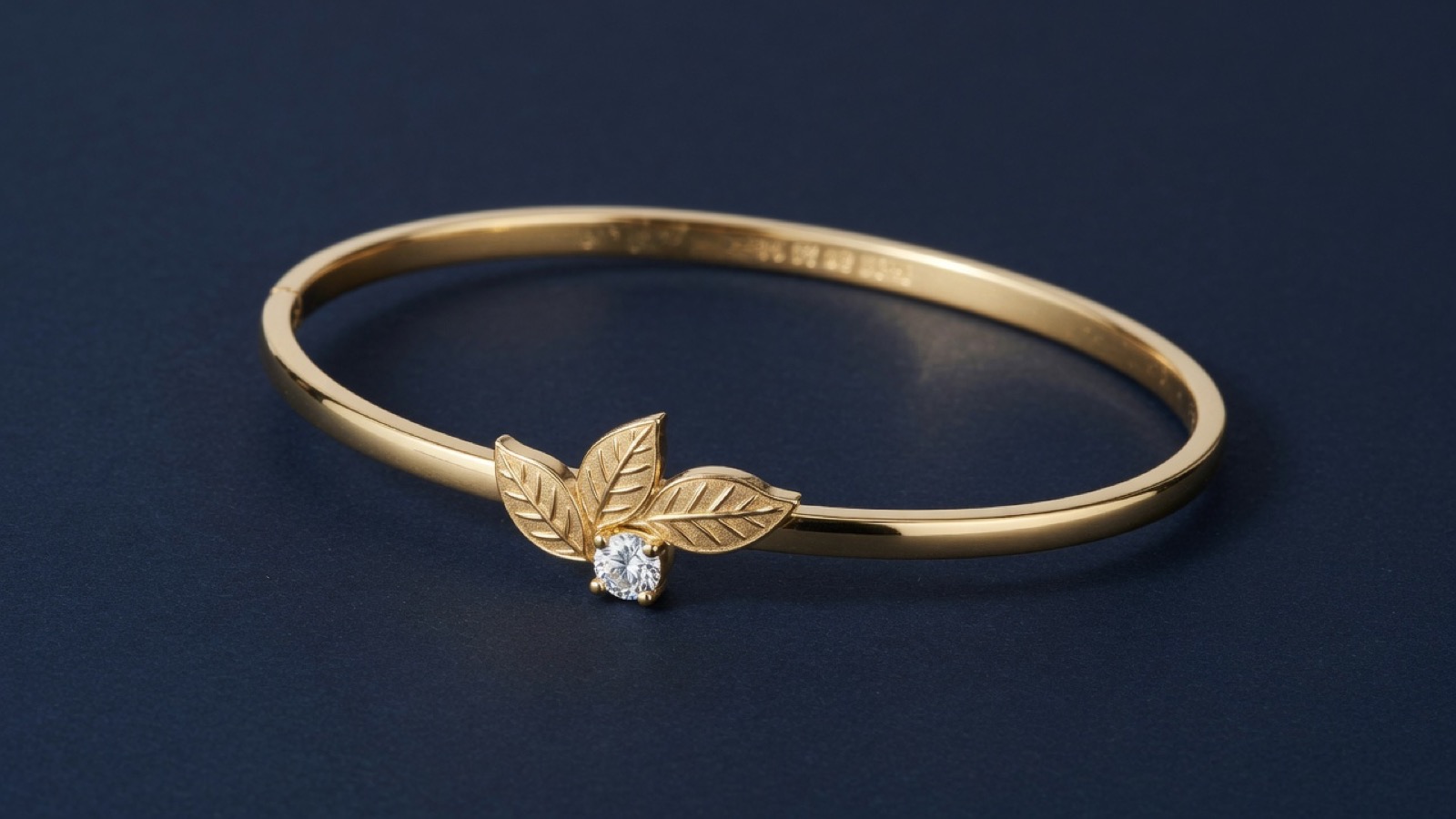 Catalog still of a custom 14k leaf bangle